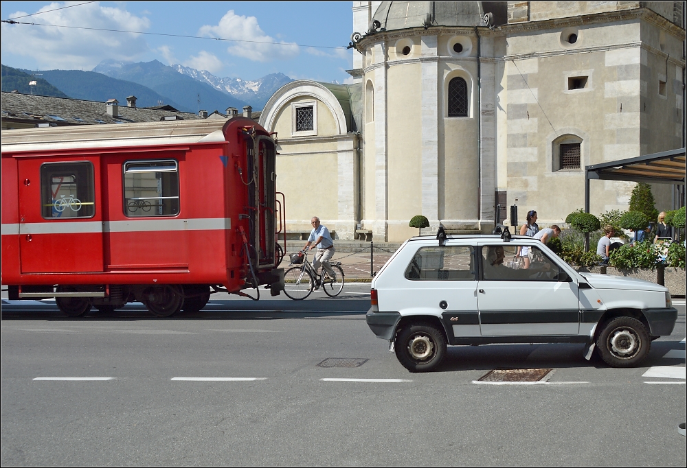 Berninabahn in Tirano.

Nach der Bahnpassage geht das Leben weiter. Es wirkt, als wrde bei jeder Zugpassage das Leben auf dem Platz fr zwei Minuten angehalten. Und jetzt geht es weiter.

Im Juli 2013.