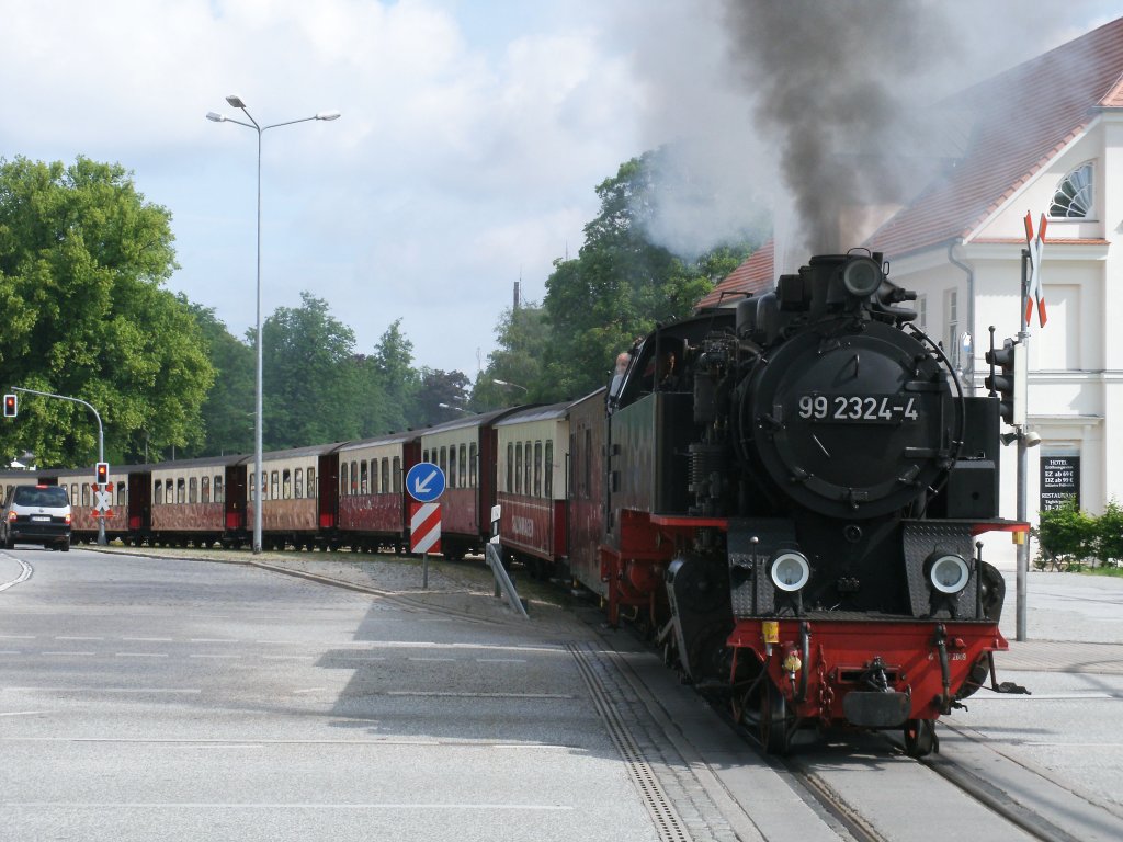 Bevor der Molli die Endstation Bad Doberan erreicht,mute,am 28.Mai 2011,99 2324 mit ihren Zug aus Khlungsborn West,die Bundesstrae 105 berqueren.