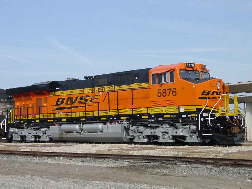 BNSF 5876 sits at the siding near the depot in Burlington, Iowa on 27 Feb 2006. Only a minor stain from the diesel on the silver paint of the fuel tank would suggest that this lok has been on the road only a few weeks, especially when compared to the unit it is coupled to!