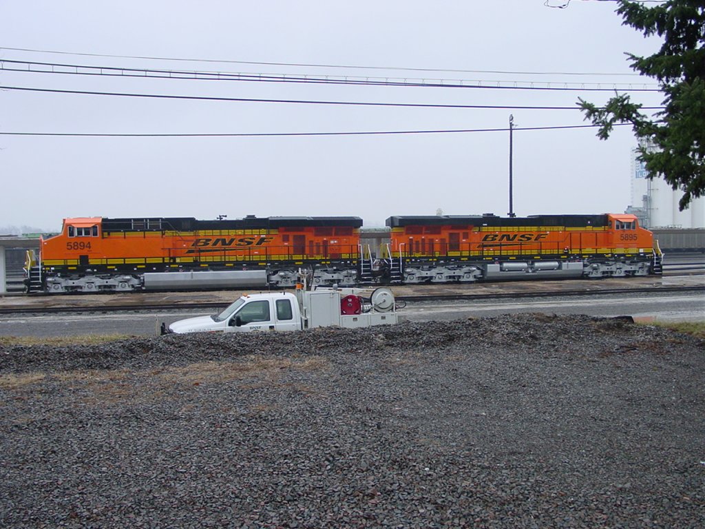 BNSF 5894 & 5895 sit on a siding at the Burlington, Iowa depot on a foggy March day in 2006. Units are near new.