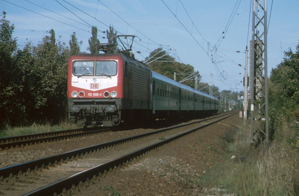 BR 112-006-3 hat gerade den Bahnhof von Schwerin HBF verlassen und fhrt seinem Ziel Berlin Lichtenberg entgegen im Jahre 1995
