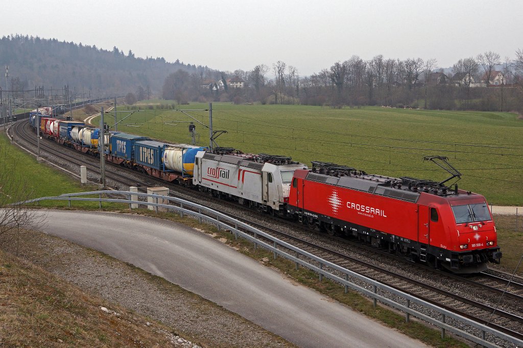 Crossrail: Schlechtwetteraufnahme mit bunter Doppeltraktion, aufgenommen zwischen Olten und Bern am 6. April 2013. An der Spitze des schweren Gterzuges ist die 185 596-4  eingereiht.           Foto: Walter Ruetsch
