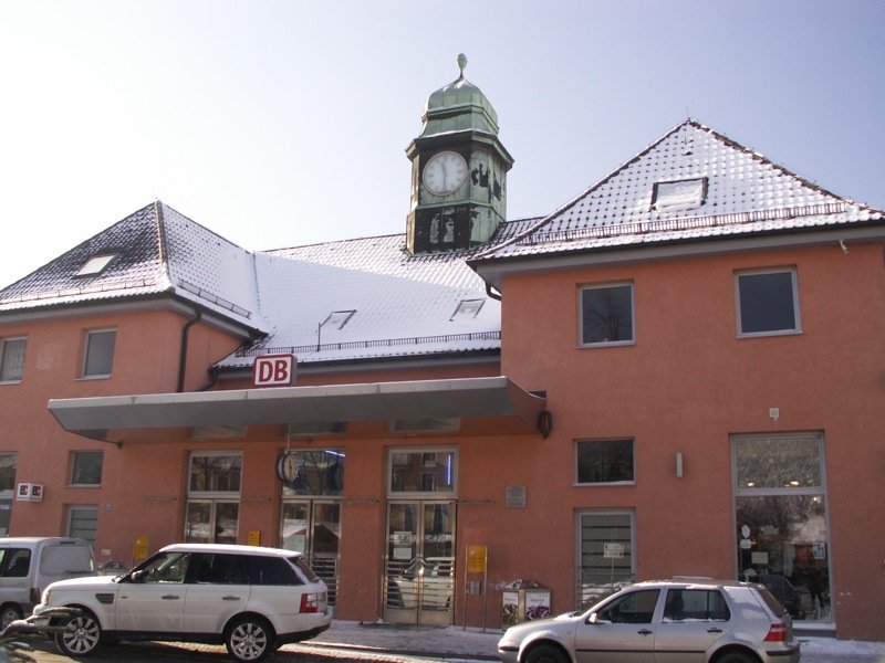 Das schne Bahnhofsgebude in Garmisch-Partenkirchen an einem verschneiten, aber sonnigem Sonntag.