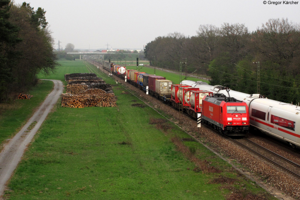 DB Schenker meets DB Fernverkehr. 185 241-7 begegnet mit einem Containerzug einer Baureihe 403. Aufgenommen am 06.04.2012 bei Graben-Neudorf.