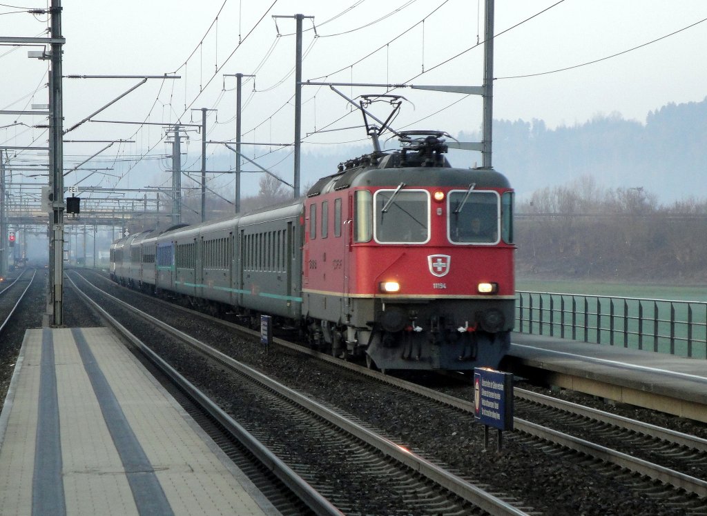 Der IR 2454 durchfhrt am 23.03.2012 gezogen von der Re 4/4  11194 den Bahnhof Dagmersellen.