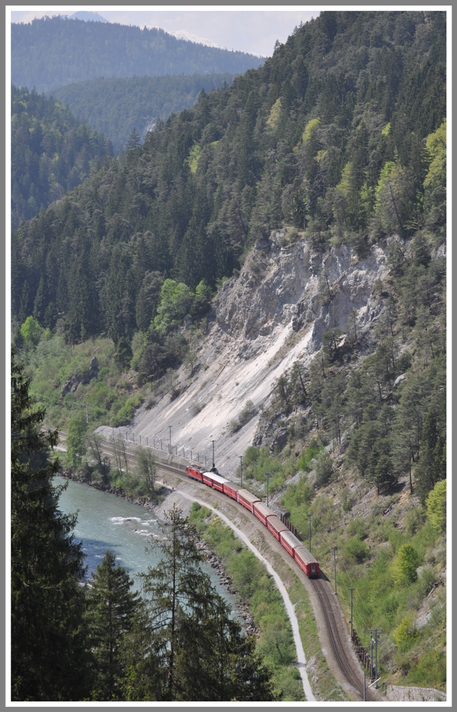 Der RE1232 hat den Dabitunnel verlassen und erreicht bald Trin. Der neuerstellte Wanderweg zwischen Bahn und Rhein ist hier gut zu sehen. (25.04.2011)