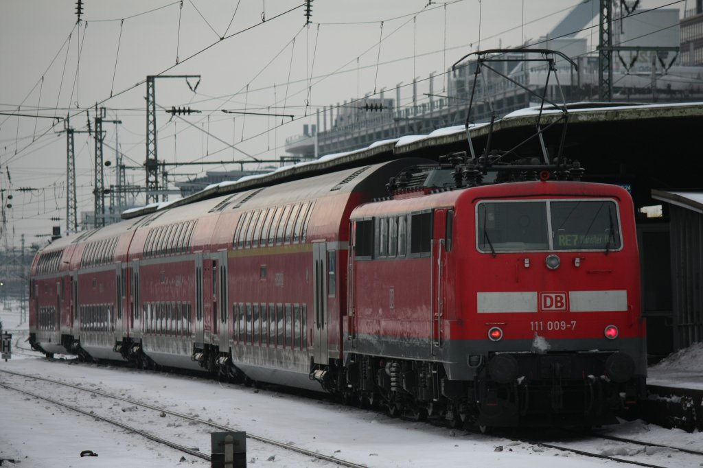 Die 111 009-7 schiebt am 27.12.2010 ihren RE7 durch Kln Messe Deutz nach Mnster Hbf.