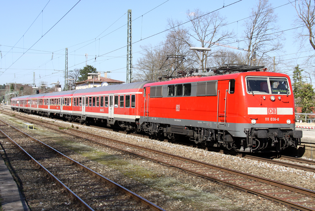 Die 111 036-0 mit der Verstrker RB von Mnchen nach Garmisch Partenkirchen bei der Abfahrt in Tutzing am 15.04.2013