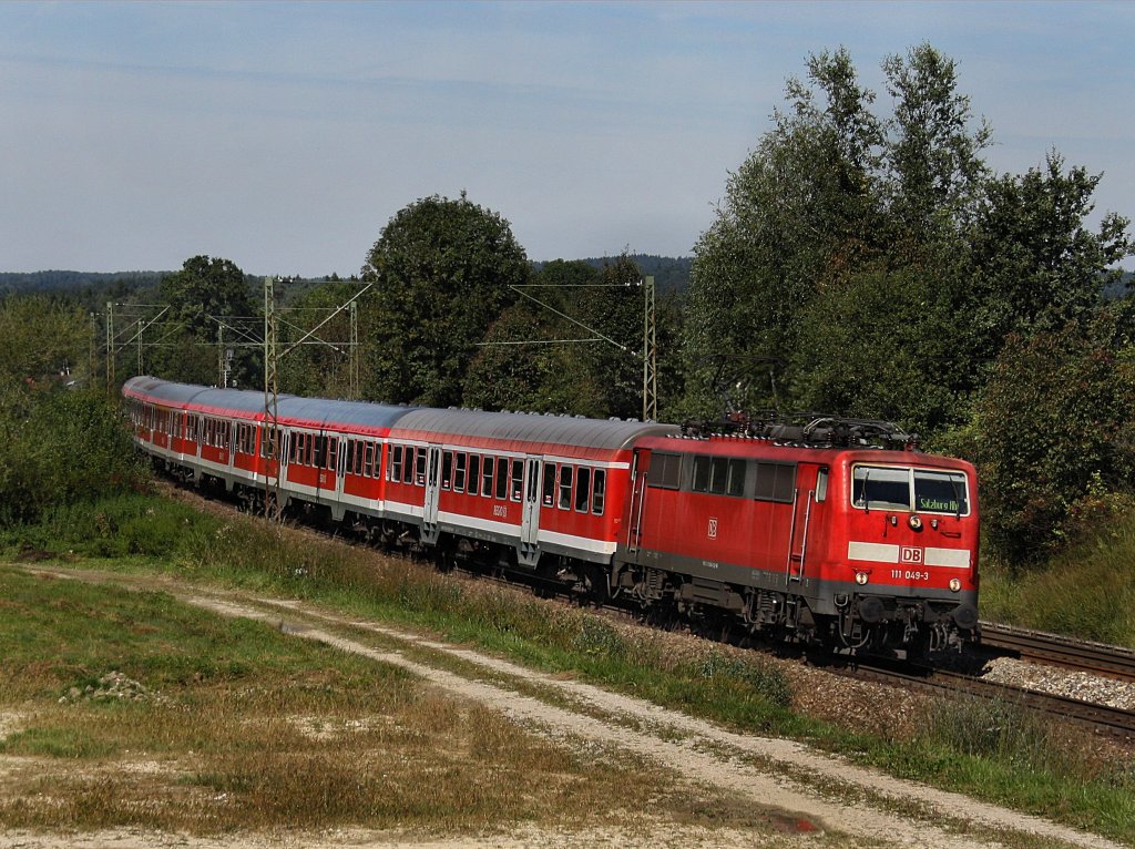 Die 111 049 am 12.09.2010 mit einem RE nach Salzburg unterwegs bei Ostermnchen. 