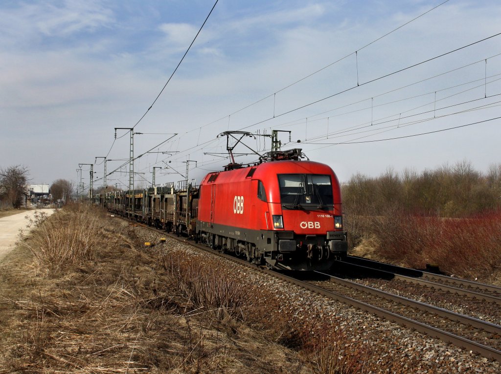 Die 1116 168 am 12.03.2011 mit einem Leeren Autozug unterwegs bei Obertraubling. 