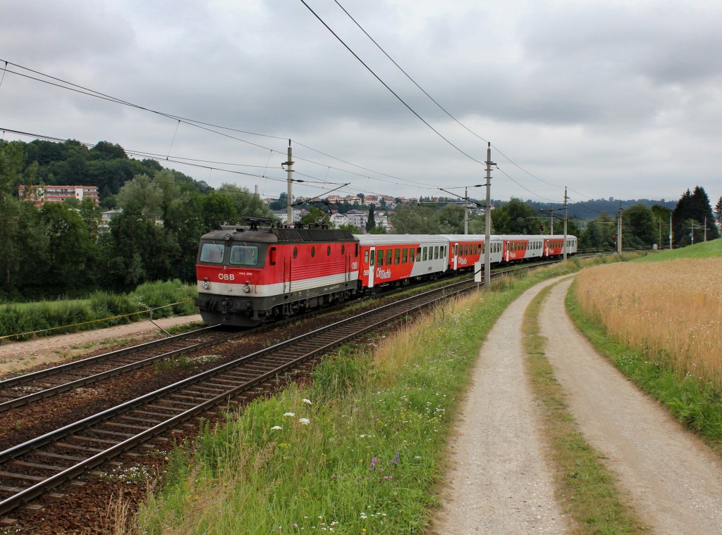 Die 1144 268 mit einem REX nach Linz am 07.07.2012 unterwegs bei Ingling.