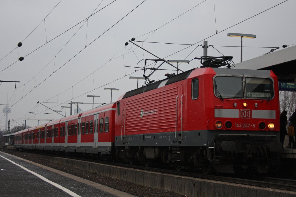 Die 143 247 mit S-Bahn Rhein Ruhr Logos am 23.2.13 mit einer S6 nach Essen Hbf in Kln/Messe Deutz.