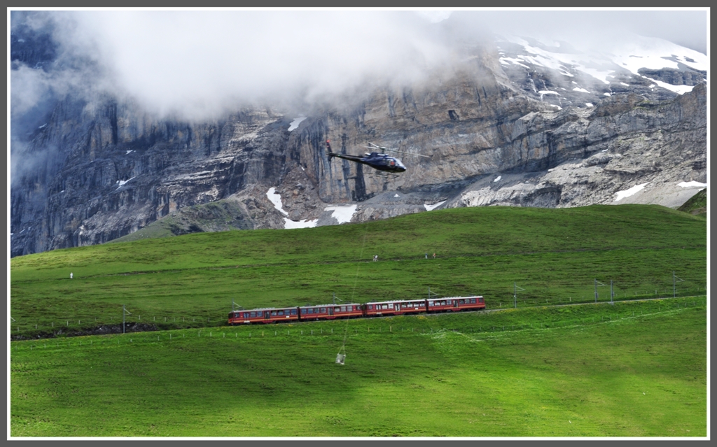 Die beiden BDhe 4/8 211 und 215 nhern sich der Kleinen Scheidegg. Auf der Wengernalp wird an einer neuen Sesselbahnstation betoniert, wobei der frische Beton direkt vom Lastwagen auf der Salzegg ber die Kleine Scheidegg geflogen wird. (26.05.2012)