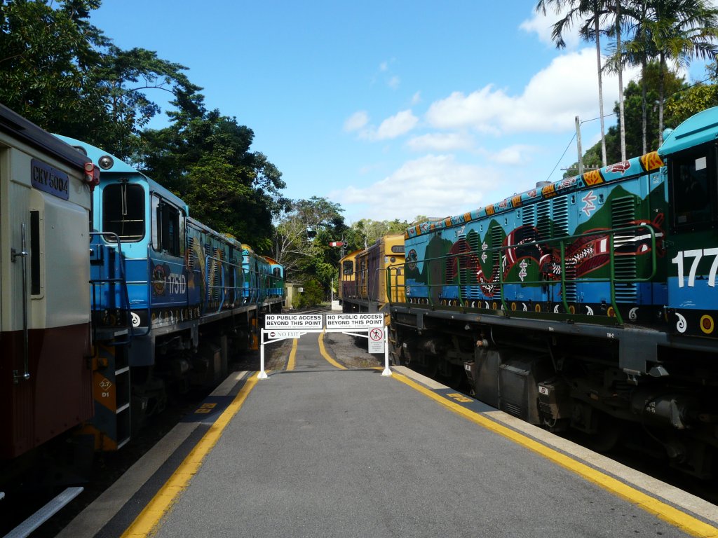 Die beiden Zge der Kuranda Scenic Railway mit den bunt bemalten Loks stehen im 'Regenwald Bahnhof' Kuranda und werden am nachmittag zurck nach Cairns fahren. Aufgenommen am 21.7.2009.