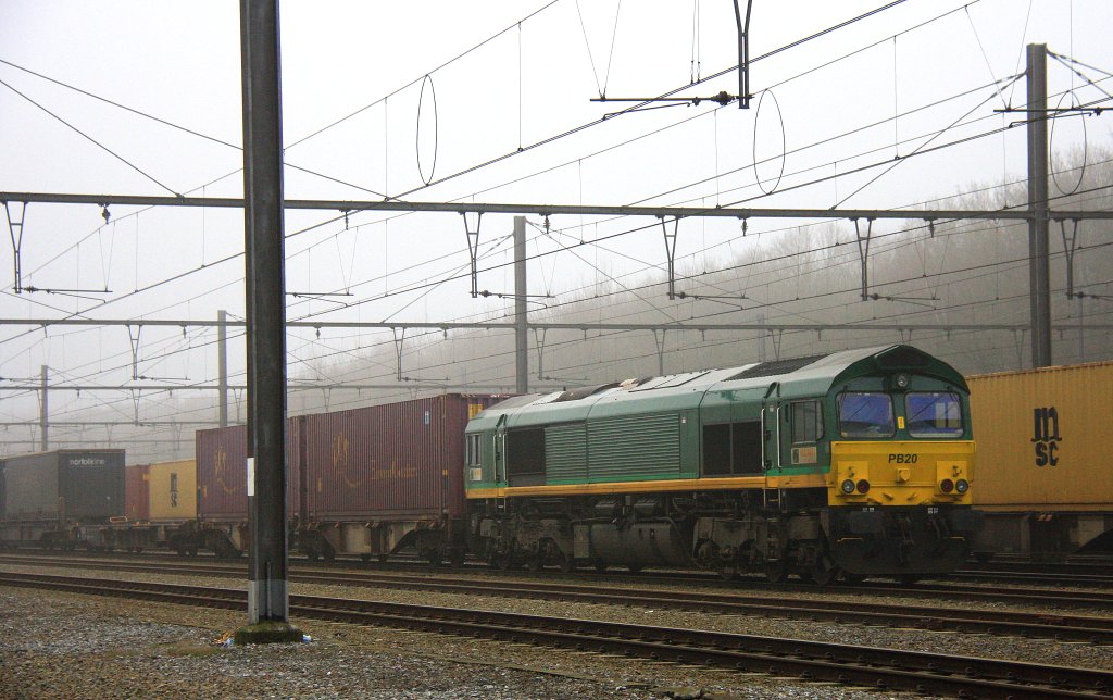 Die Class 66 PB20 von Railtraxx BVBA steht in Montzen-Gare(B) mit einem sehr langen Containerzug im Nebel am 6.1.2013.