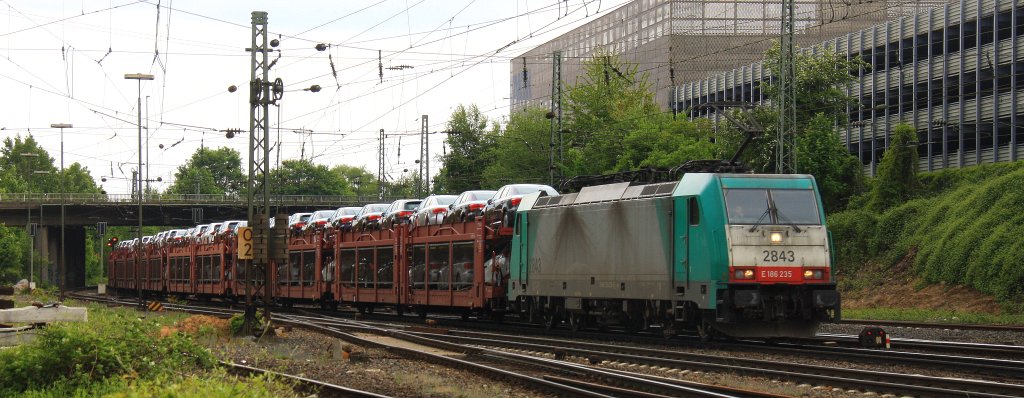 Die Cobra 2843 kommt mit einem sehr langen Toyota-Autozug aus Zeebrugge-Ramskapelle(B) nach Mszczonow(PL) und f�hrt in Aachen-West ein bei Sonne und Regenwolken am 25.5.2013.