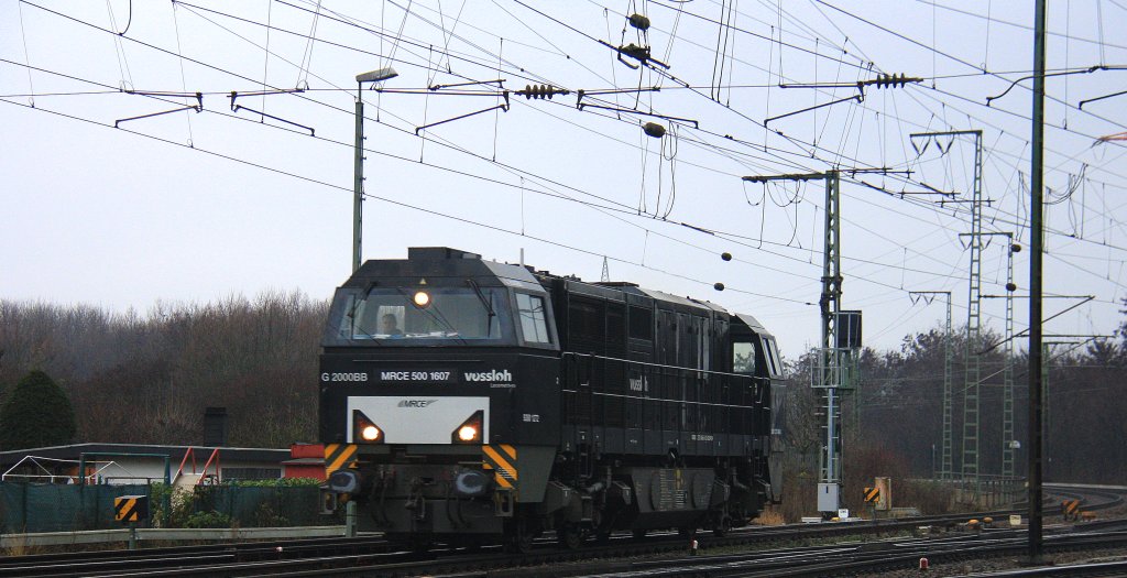 Die MRCE 500 1607 von der Neusser Eisenbahn kommt als Lokzug durch Kln-Gremberg und fhrt in Richtung Koblenz bei Regenwolken am 21.12.2012.