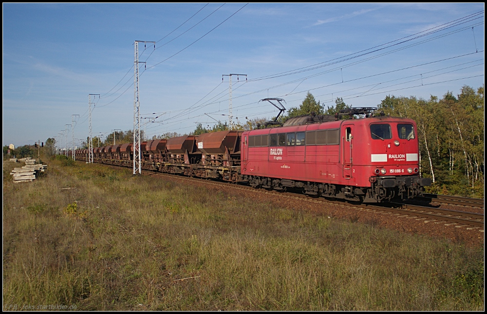 Die orientrote RAILION DB Logistics 151 086-6 mit Schttgut unterwegs in Richtung Eichgestell (gesehen Berlin Wuhlheide 13.10.2010)