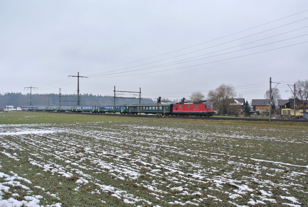 Die Re 4/4 II 11134 mit dem Ersatz RE 3221 bei Lyssach, 02.03.2013.