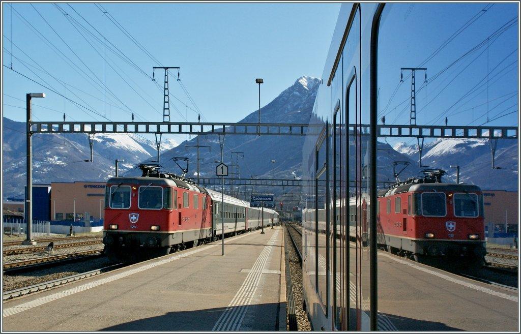 Die SBB Re 4/4 II 11217 erreicht mit ihren IR 2159 von Basel nach Locarno Cadenazzo, wo sich sich im Anschlusszug nach Luino spiegelt.
21. Mrz 2013