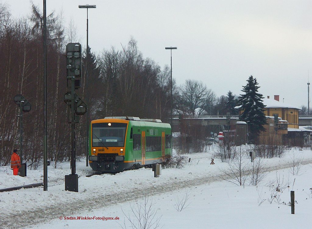 Ein VT von der Waldbahn tut im Moment Dienst in Oberfranken. Er pendelt zwischen Hof und Mnchberg und wenn die Nebenbahn nach Helmbrechts wieder in Betrieb geht, auch dorthin. Hier wurde er am 5. Januar 2011 bei Ausfahrt aus Oberkotzau erwischt. Links ein DB-Mitarbeiter der manuell Schnee von den Weichen putzte und auch ein Behltnis mit Schmiermittel f.d. Weichen dabei hatte. Hinter dem Zug ist die Strecke nach Selb zu vermuten und das dort am EG befindliche Bahnsteigdach ist jngst durch die Schneelast heruntergebrochen...