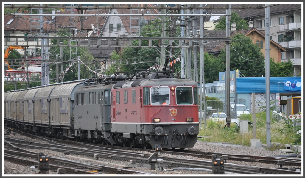 Eine eher ungewhnliche Bespannung weist dieser Gterzug auf. Die Re 4/4 III 11367 leistet bei Zug 62867 einer unbekannten Ae 6/6 Vorspann bei der Durchfahrt durch Zrich Oerlikon. (14.07.2011)