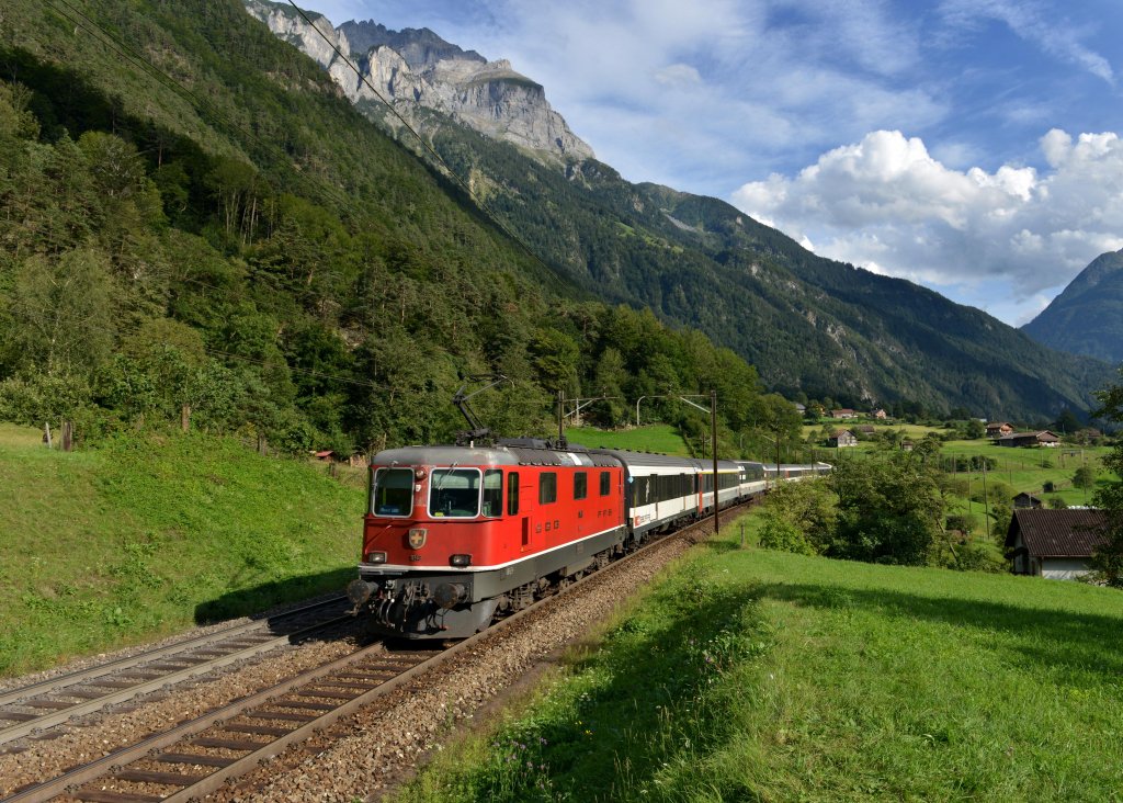 Eine Re 4/4 mit einem IR von Locarno nach Basel am 29.08.2012 unterwegs zwischen Amsteg-Silenen und Erstfeld.