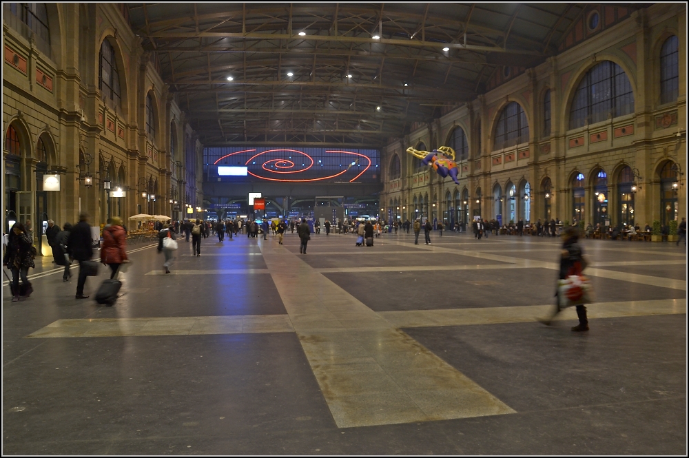 Feierabendimpressionen - Zrich im Mrz 2011. Die riesige, leere Bahnhofshalle mit schwebender Nana zur abendlichen Rushhour. Dahinter halten die Zge. Die Nana kann ich leider nicht zur Gnze zeigen, denn dann knnte das Hundertwasserurteil zutreffen...