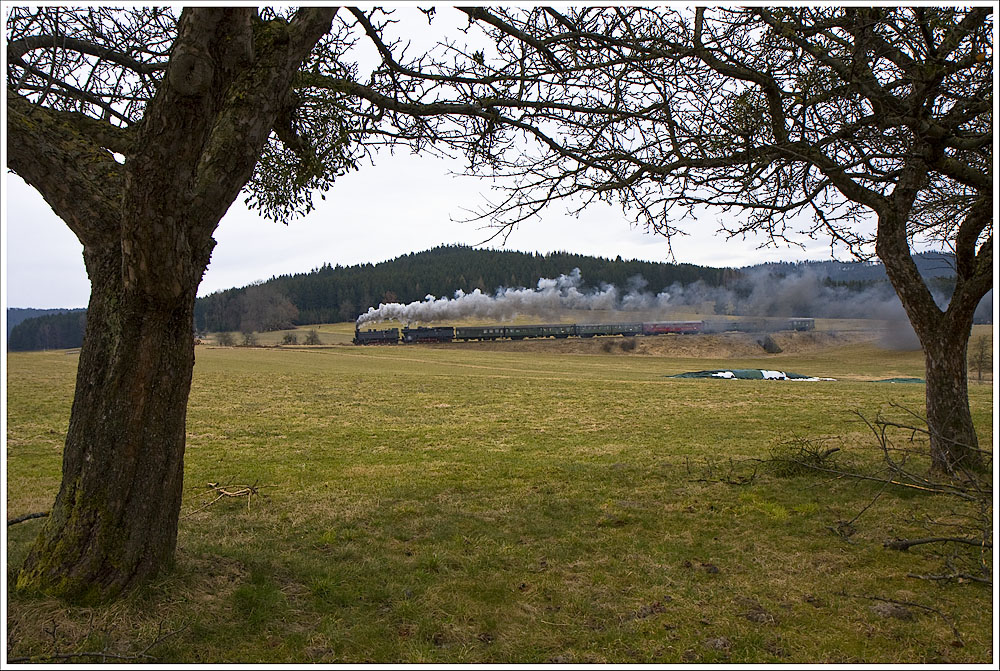 Gleich nach dem Bhf Hausruck quert die Strecke dem Hang entlang Richtung Scheiteltunnel. Die 77.28 und 78.618 befördern hier den R14316 (Simbach-Ried-Attnang-Puchheim) bergwärts. 13.3.2011