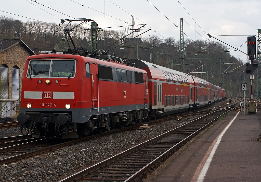 Im Sandwich fhrt der RE 9 (Rhein-Sieg-Express) von Kln kommend am 14.04.2012 in den Bahnhof Betzdorf/Sieg ein. Zuglok ist 111 077-4 und Schublok die 111 075-8.