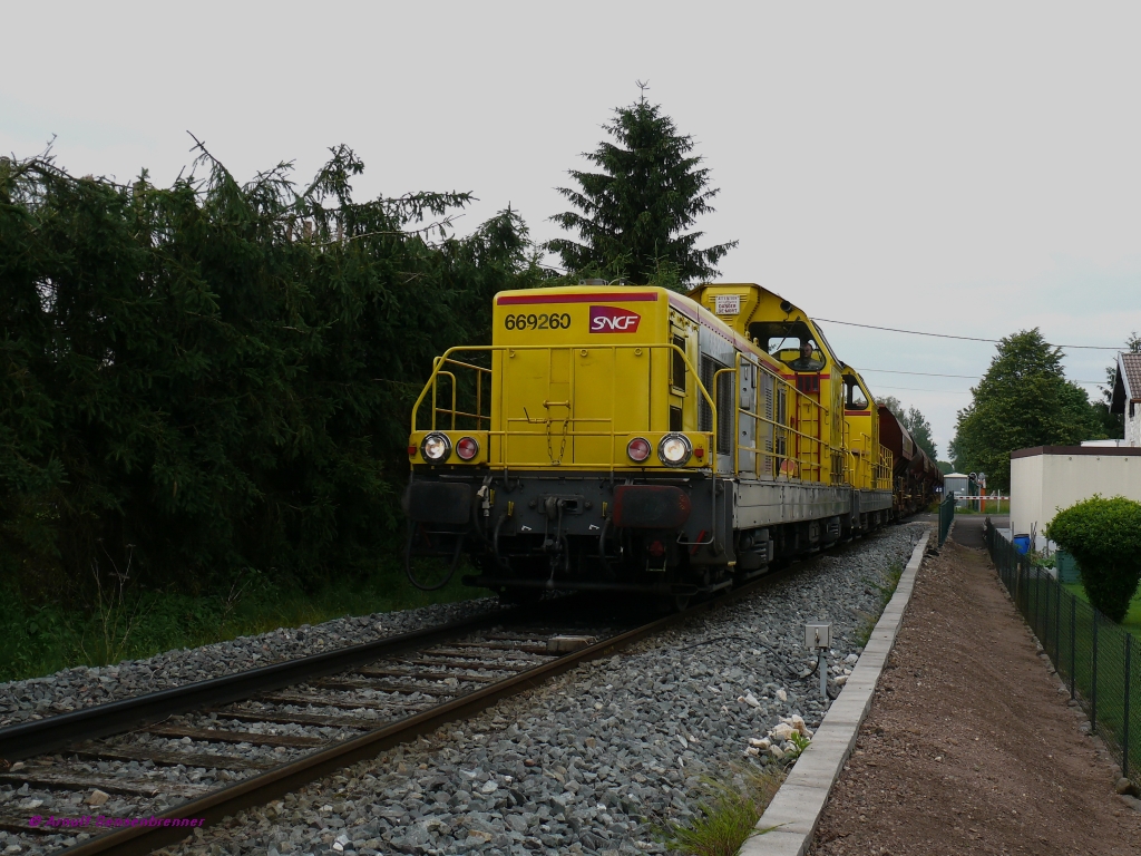 In Magny-Vernois bei Lure ist hier ein Materialzug fr die Hochgeschwindigkeitsneubaustrecke LGV-Rhin-Rhne auf der eigens dafr wieder in Betrieb genommene Strecke von Lure nach Villersexel unterwegs.
Aufgrund der starken Steigungen wird der Zug mit Vierfachtraktion gefahren.
Vorne ziehen hier die beiden SNCF-Infra-Loks BB69260+BB69309 und hinten schieben die beiden BB69297+BB69264. 
21.06.2010 Magny-Vernois (bei Lure)

