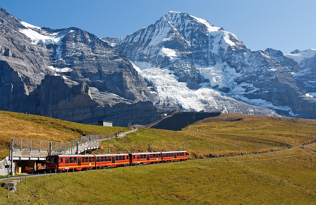 Jungfraubahn (JB) Triebwagen BDhe 4/8 - Nr. 211 und 214 fahren am 02.10.2011 von der Kleinen Scheidegg ninauf zum Eiger Gletscher, dann geht es in den ber 7 km langen Tunnel durch Eiger und Mnch bis auf das Jungfraujoch.
Bild Mitte Mnch 4.107 m .M., rechts das Jungfraujoch.
Auf einer Lnge von 9.34 Kilometern werden fast 1.400 Hhenmeter berwunden. Die Spurweite betrgt 1.000 mm mit Zahnradsystem Strub , die Hchstgeschwindigkeit betrgt 27 km/h (bergwrts) und 14 km/h (talwrts).