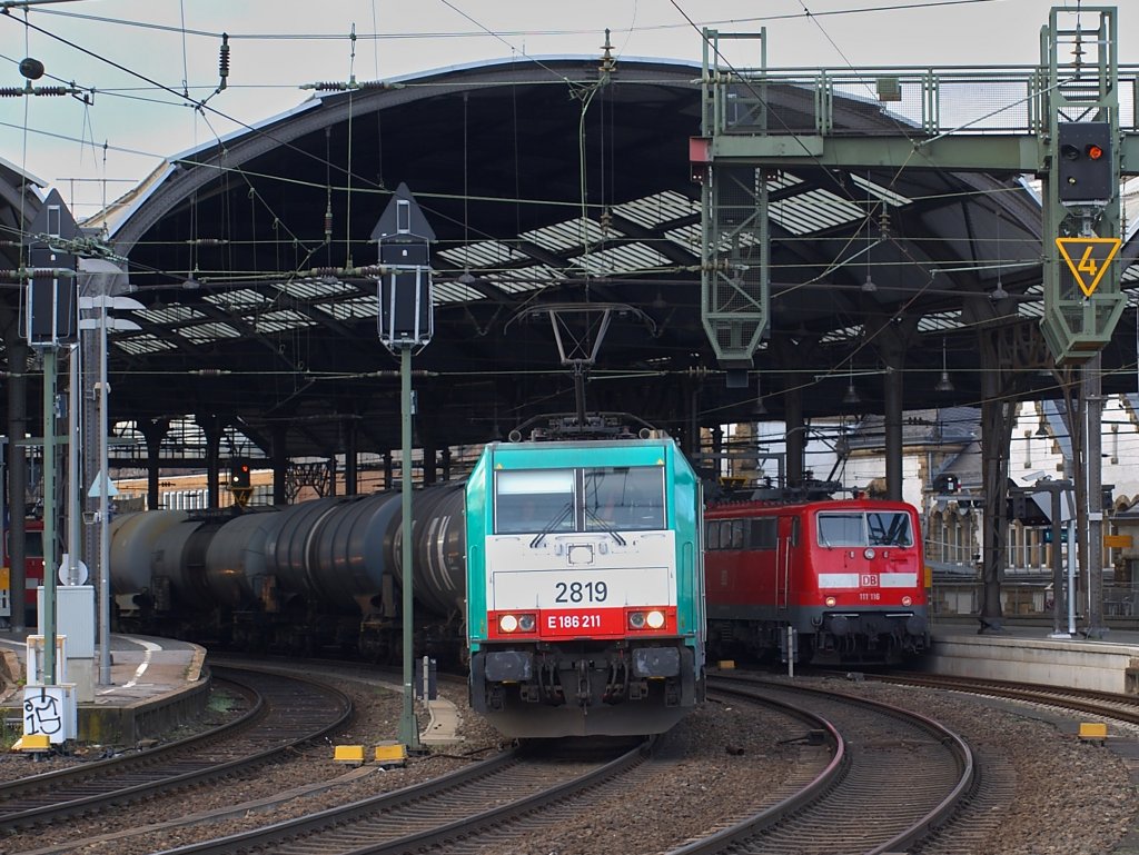 Laut polternd zieht 186 211 am 20.11.2010 einen Kesselzug auf Gleis 5 durch den Aachener Hbf. Auf Gleis 3 steht 111 116 um den RE4 nach Dortmund zu schieben.