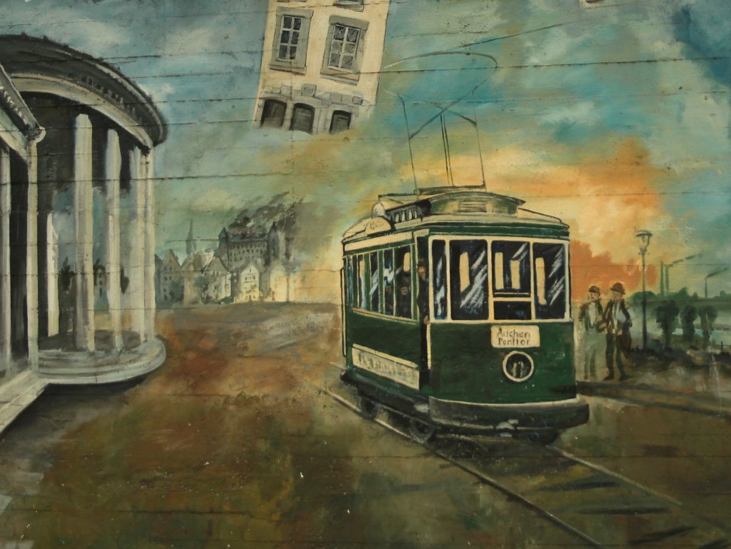 Legales Graffiti auf dem Luftschutzbunker in der Scheibenstrasse in Aachen (08.09.2011). Dort sind mehrere Bilder an der Bunkerwand zu sehen, die sich mit der Aachener Geschichte beschftigen. Hier ein Bild der Aachener Strassenbahn die von 1880 bis 1974 in Aachen und dem Umland fuhr. Mit einer Streckenlnge von ber 180 Kilometern war die Aachener Strassenbahn eine echte berlandbahn, die auch nach Belgien und in die Niederlande fuhr. 1972 beschloss der Aachener Stadtrat die Einstellung der Straenbahn, am 29.09.1974 fuhr die letzte Bahn durch Aachen. Zur Zeit wird in Aachen wieder ber eine neue Stadtbahn nachgedacht.