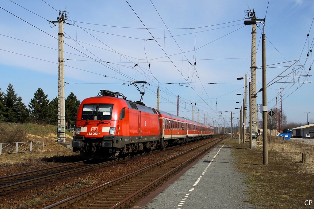 Mit dem RE 18458 nach Leipzig fhrt 182 003-4 durch den Bahnhof Doberschtz. Die viereckigen Betonmasten sind brigens eine Besonderheit dieser Strecke, sie wurden von der DR zur Einsparung von Stahl bei Quertragwerken entwickelt, konnten sich aber offensichtlich nicht durchsetzen. (23.03.2011)