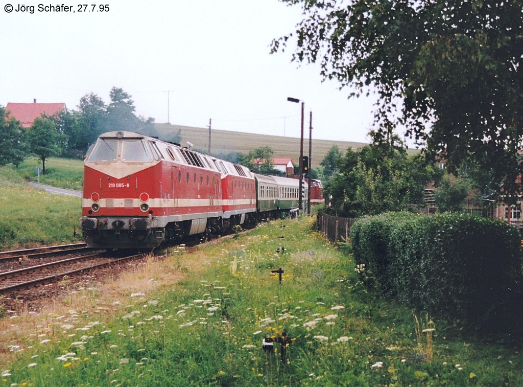  Nachschuss  auf den morgendlichen Personenzug nach Triptis in Knau. Im Hintergrund ist gerade noch die Zuglok zu erkennen. 219 085 und eine Schwesterlok fuhren im Leerlauf am Zugschluss mit - sie hatten am frhen Morgen einen Gterzug nach Ebersdorf-Friesau gebracht. 

