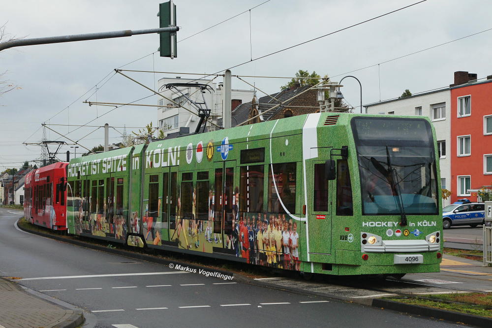 Niederflurwagen 4096 trgt eine neue Ganzreklame  Hockey in Kln . Zu sehen an seinem ersten Linieneinsatztag mit der neuen Werbung an der Haltestelle Weiden Schulstrae am 06.10.2012.