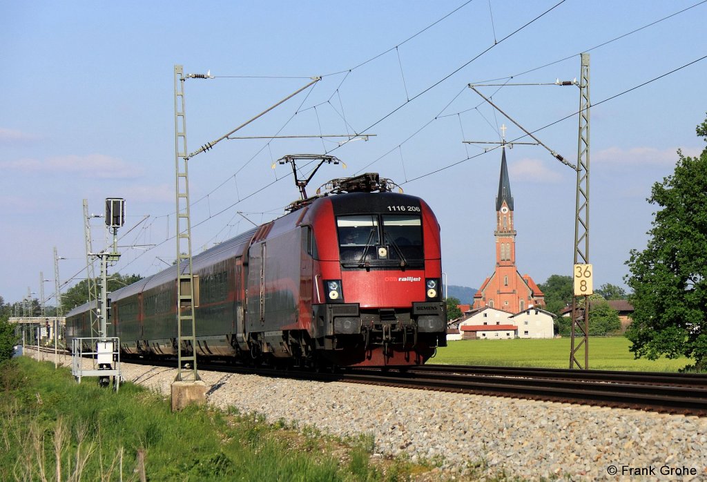 BB 1116 206 vor Railjet RJ 64 Budapest - Mnchen, KBS 951 Salzburg - Rosenheim - Mnchen, fotografiert bei bersee am 14.05.2012 --> im Hintergrund die neogotische Kirche St. Nikolaus von bersee 