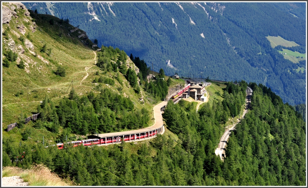 R1641 nach Tirano steht in der Station Alp Grm und BerninaExpress 960 hat diese Kreuzungsstelle soeben verlassen. (11.08.2012)