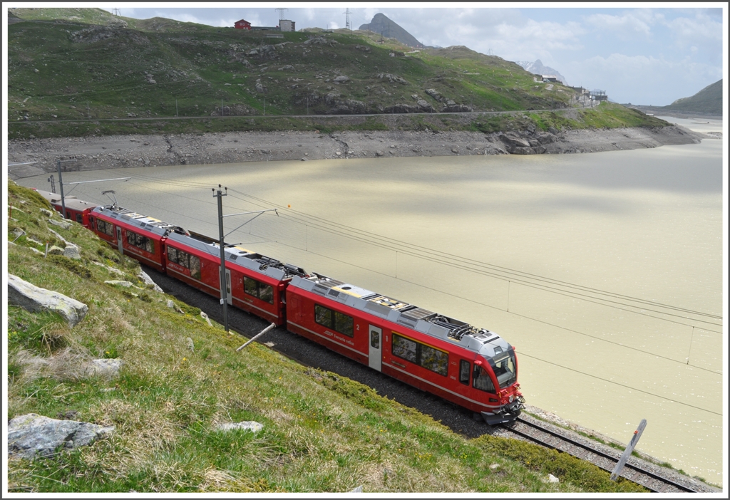 R1648 mit ABe 8/12 am zur Zeit braunen Lago Bianco. Am rechten Bildrand erkennt man die hchste RhB Station Ospizio Bernina 2253m /M. (21.06.2012)