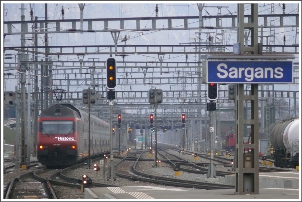 Re 460 102-7  Historic  schiebt den IC575 aus dem Bahnhof Sargans Richtung Chur. Die zwei brandgelben Signallampen sind fr den RJ169 bestimmt, der hier 4 Minuten spter die Fahrbahn des IC575 kreuzen wird. (04.01.2010)