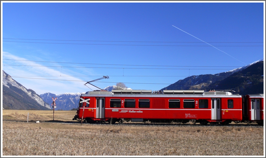 S1 1521 mit Be 4/4 passiert den unbewachten Bahnbergang bei der Kapelle Sogn Mang bei Bonaduz. (08.02.2011)
