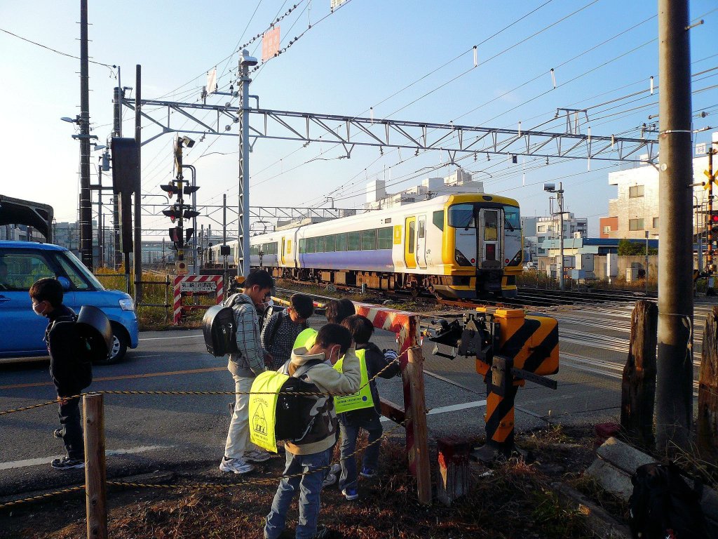 Serie 257: Im grellen Morgenlicht fährt ein Zug der Bôsô-Halbinselstrecken mit Steuerwagen KUHA 256-515 aus der Station Kisarazu aus, 27.November 2009. 