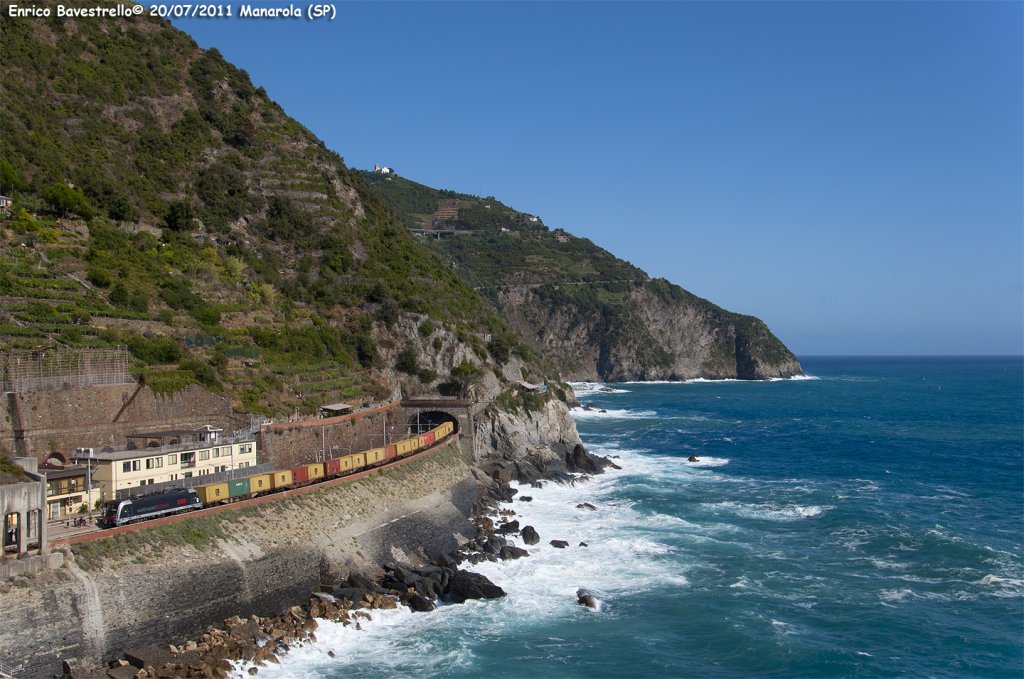 The OBB E190.025 with  Guinness world record  livery (actually in service for Linea Smart Business Ways) passes in Manarola heading the TCS train n. 54026 from La Spezia Migliarina to Rho. (July 20, 2011)
