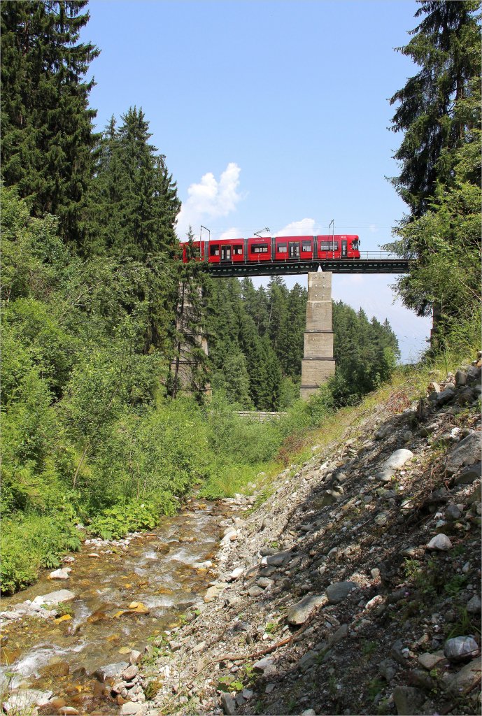 ber den kleinen aber reienden Mhlbach fhrt ein IVB-Flexity Outlook Triebwagen auf der Stubaitalbahn Richtung Fulpmes. Mhlgrabenviadukt, zw. Mutters und Raitis, 30.6.12