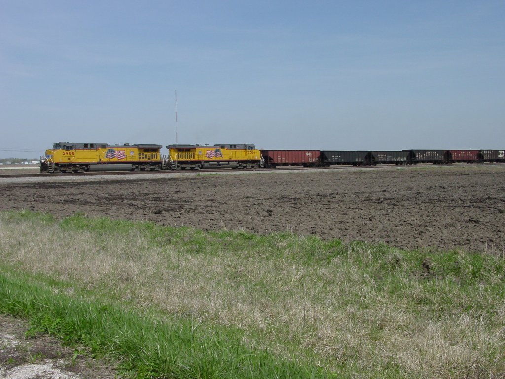 Union Pacific 5988 & 5561 pull an empty coal train on the BNSF double track main line westbound near Middletown, Iowa on 15 Apr 2005.