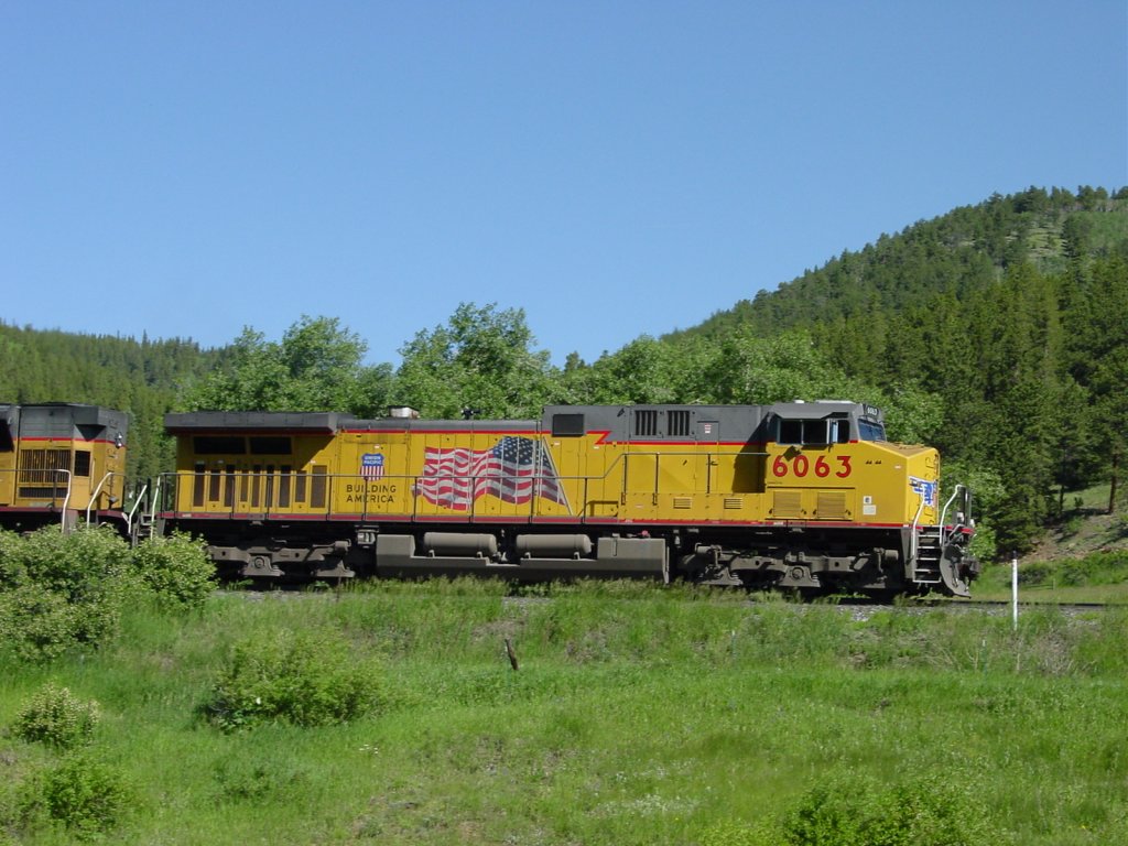Union Pacific 6063 in Building America paint scheme haul a loaded coal train down the hill near Rollinsville, Colorado on 1 July 2005.