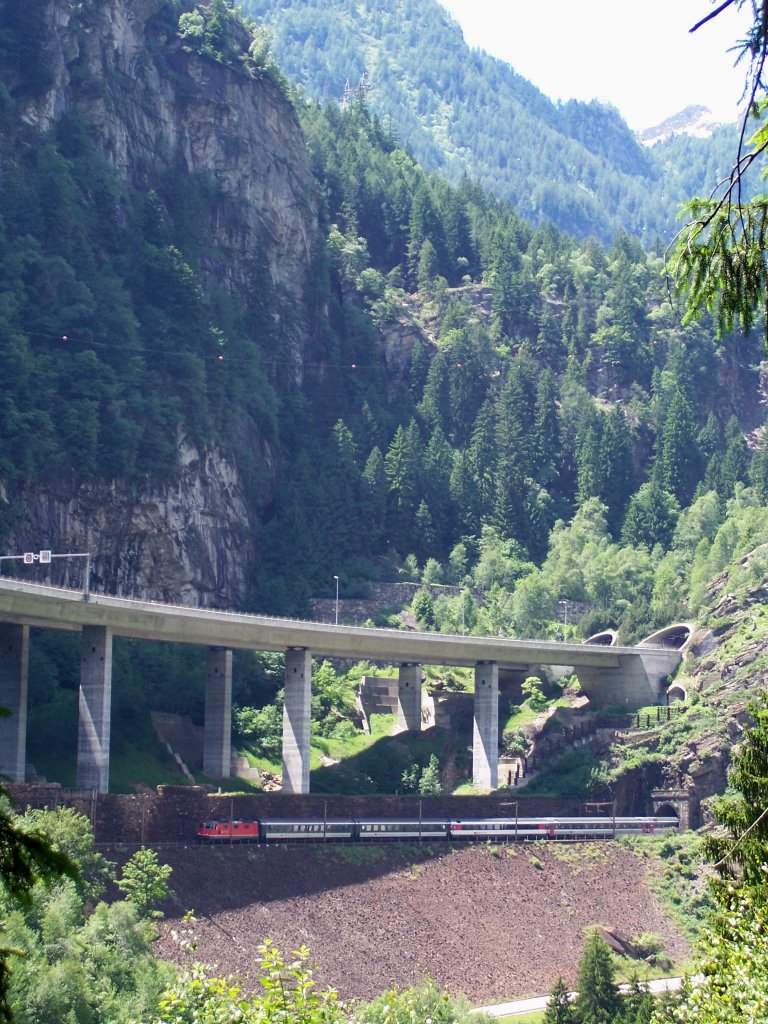 Unter der Autobahn und ber der Landstrae talwrts fahrender Personenzug bei der Ausfahrt aus dem Prato-Kehrtunnel. In Krze wird der Zug Faido erreichen, 11.06.2009.