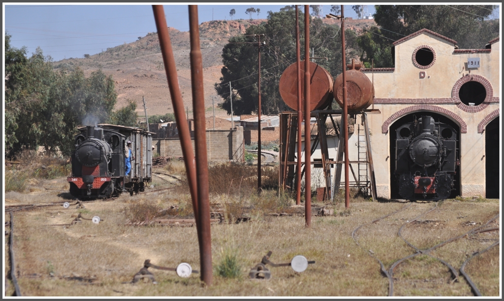 Vor dem Depottor steht 442.56 und 202.002 rangiert Gterwagen. Im Hintergrund ist das Streckengeleise nach Massawa sichtbar und das Anschlussgleis zum Ausbesserungswerk Asmara. (31.01.2012)