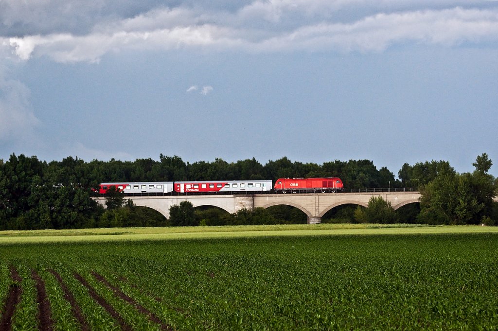 Vor den drohenden Gewitterwolken am 03.06.2011 hat der REX 2523 wieder �sterreichisches Staatsgebiet erreicht. Die Aufnahme entstand bei Marchegg.